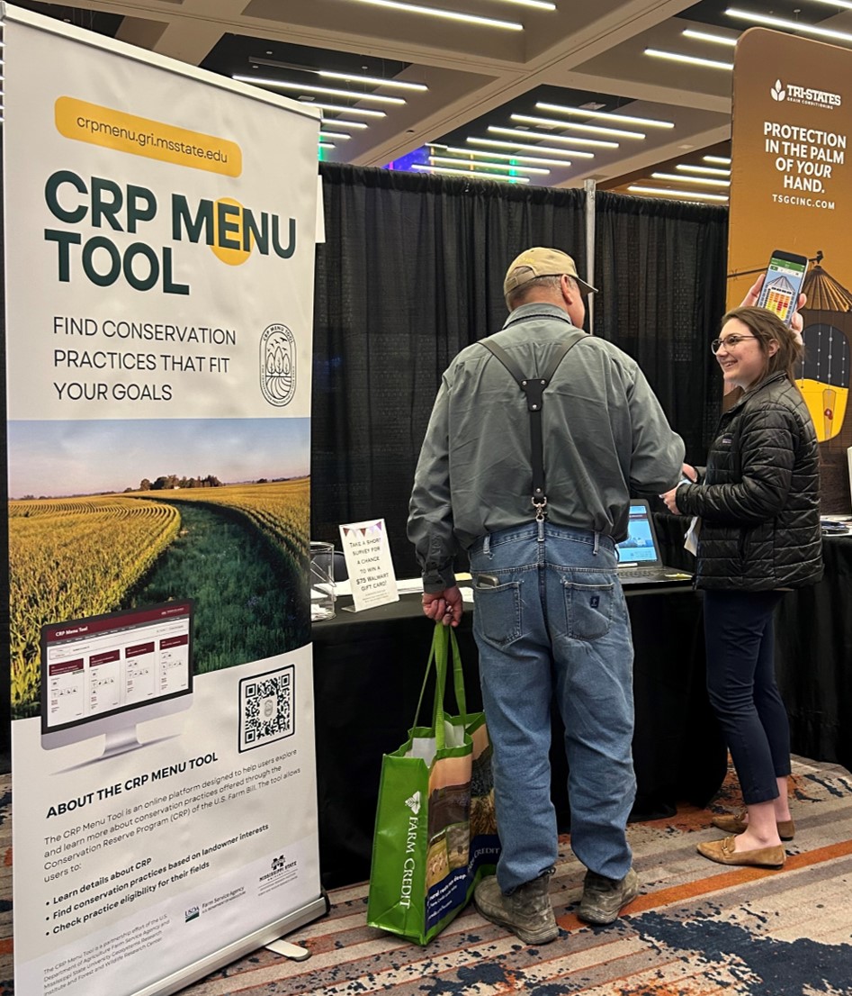Hopper with Landowner at Booth